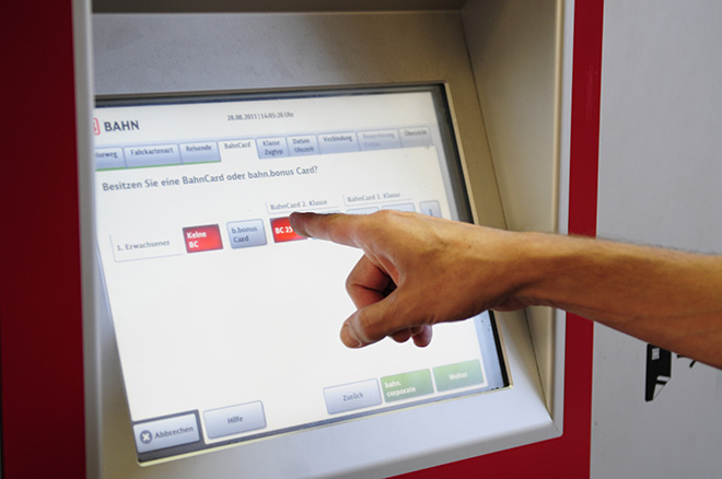 Public Transport - Train ticket vending machine a hand touching a screen