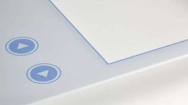कस्टम टच स्क्रीन - सफेद और नीले लोगो के क्लोजअप को रिवर्स प्रिंट करना