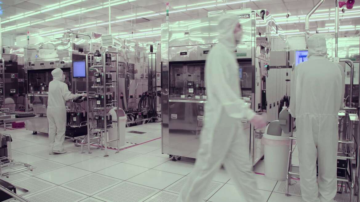 Viwanda Monitor - Cleanroom mkutano mtu katika suti nyeupe kutembea katika kiwanda