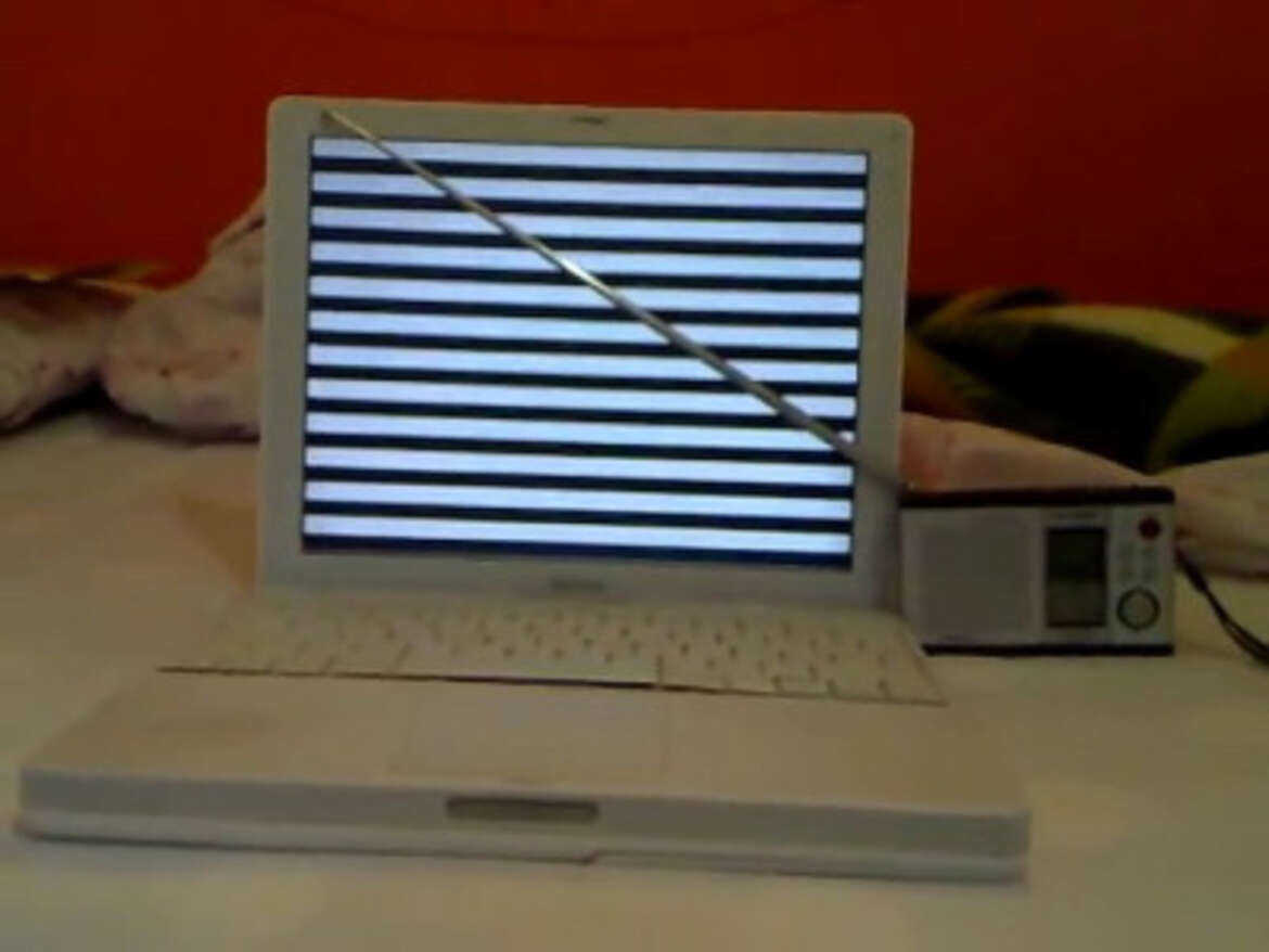 Tempest for Eliza a laptop with a radio antenna in fron of the screen
